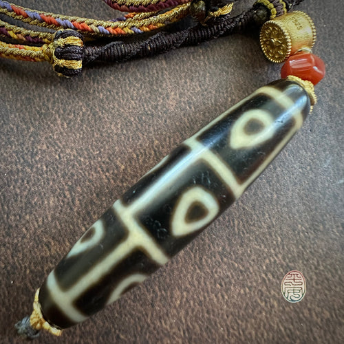 Buddha’s Heart 9 -Eye dZi bead on Waven  Cord Necklace